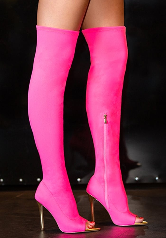 A sexy stretch-to-fit over-the-knee boot featuring a peep toe, stiletto heel, and zipper closure