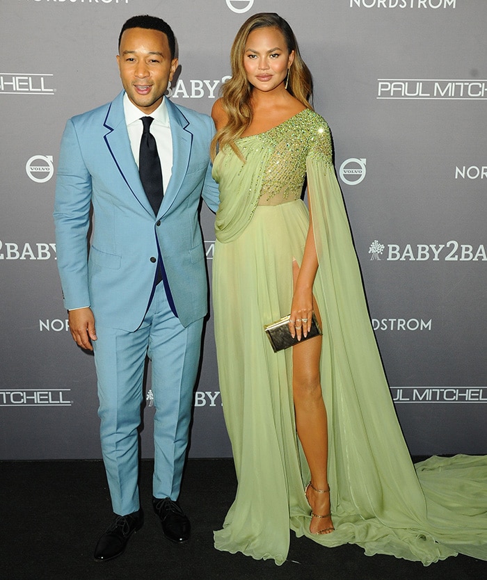 John Legend wears a blue suit as he joins Chrissy Teigen on the black carpet at the Baby2Baby Gala 2019