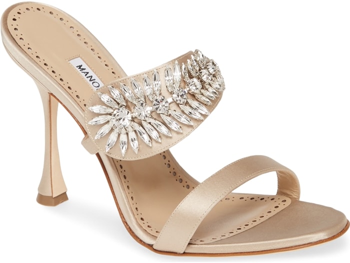 A slide style sandal gets a gorgeous lift with a curvy heel and glittering crystals that catch and reflect the light
