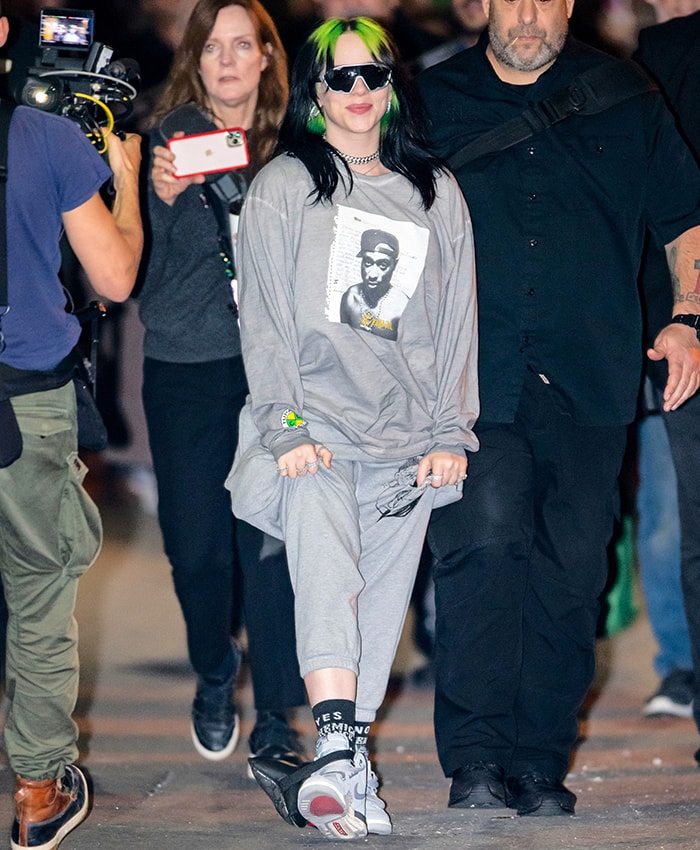 Billie Eilish in gray sweat pants and Nike Jordan Legacy 312 “Wolf Grey” sneakers outside Jimmy Kimmel Live studios on November 21, 2019