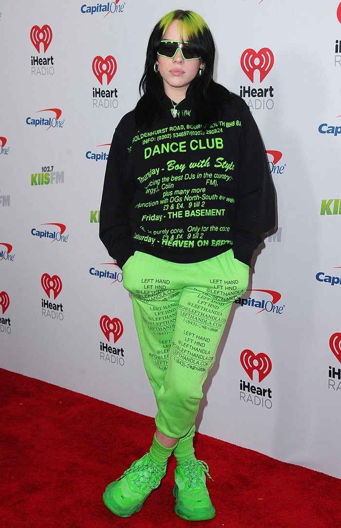 Billie Eilish in MISBHV green sweater, Left Hand LA pants and Balenciaga Triple S Sneakers at KIIS FM's iHeartRadio Jingle Ball 2019 on December 6, 2019