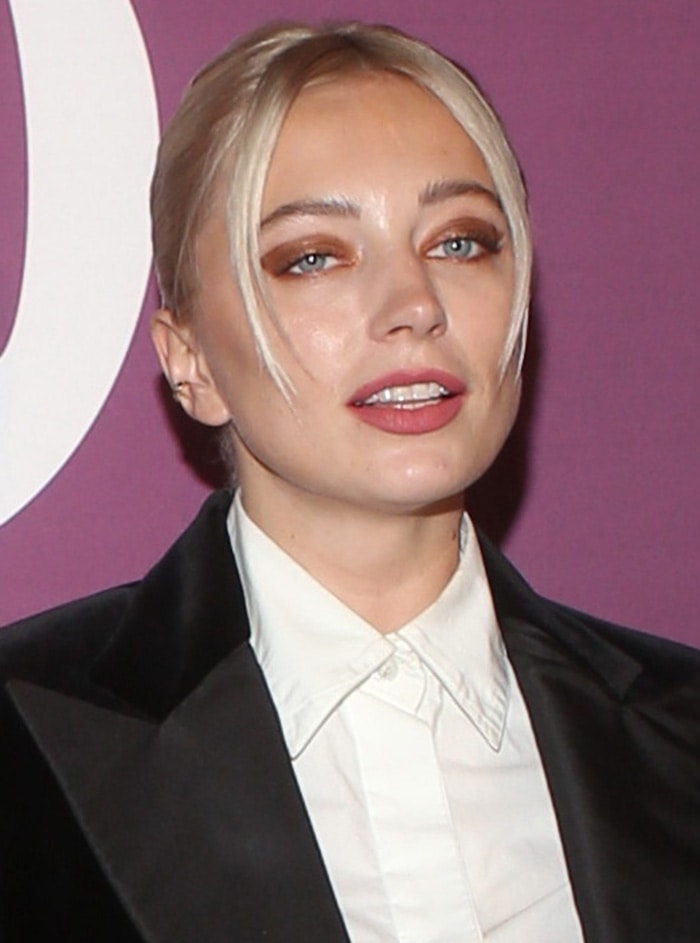 Caroline Vreeland wears a chic updo with face-framing fringe and bronzed eyeshadow