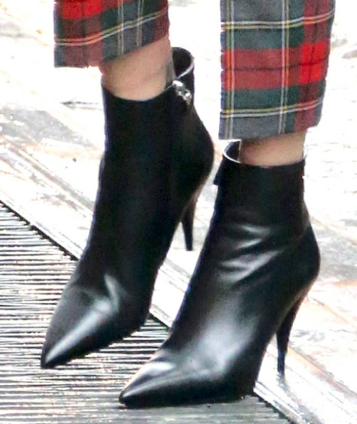 Charlize Theron teams her cropped tartan pants with black pointed-toe boots