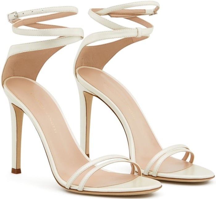 These high-heel, cream coloured patent sandals feature a front strap formed by two thinner straps and a wrap ankle strap