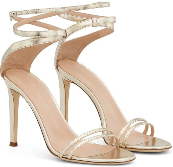 These high-heel platinum patent sandals feature a front strap formed by two thinner straps and a wrap ankle strap