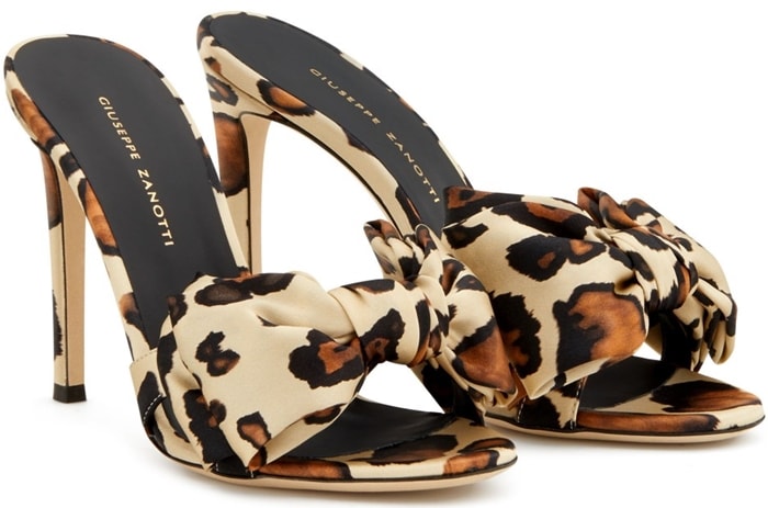 These high-heel, animal-print, silk mule sandals are embellished by the Bow accessory, and feature a covered heel