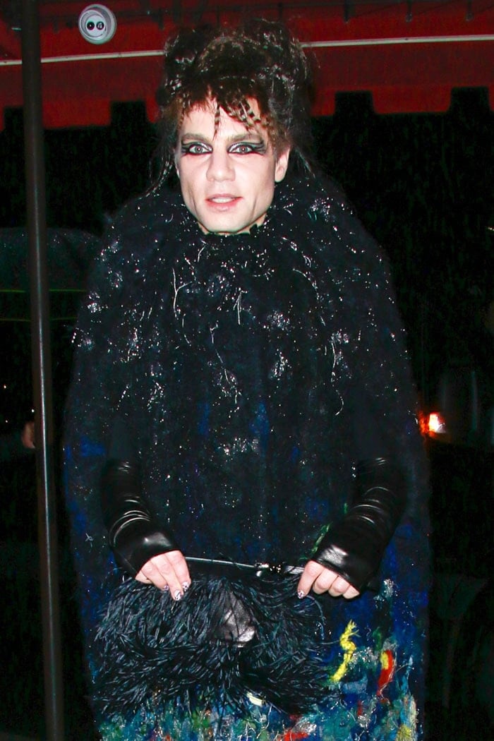 Jordan Roth carrying a feather-covered purse to the Cats premiere after party