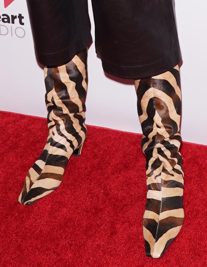 Katie Holmes wears the Khaite zebra-print slouch boots