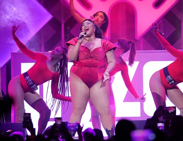 Lizzo performs in a red embellished bodysuit at the 2019 Jingle Ball Concert in Philadelphia on December 11, 2019