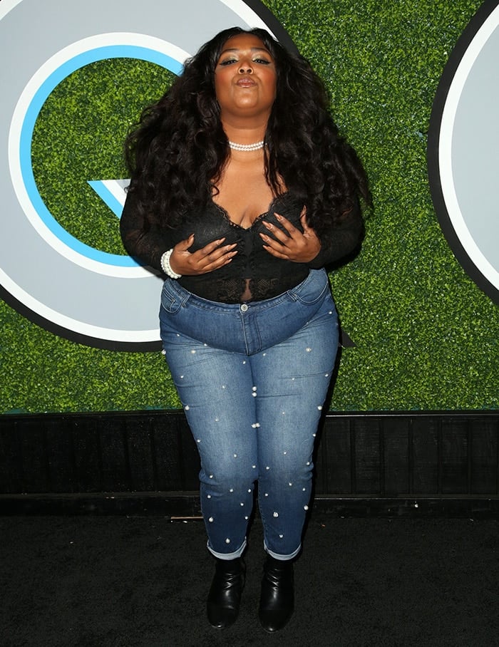 Lizzo gropes her breast while posing for photos at GQ Men of the Year Awards on December 7, 2017
