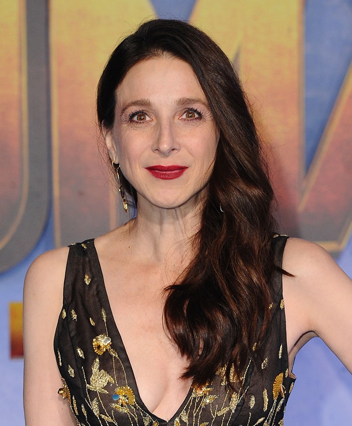 Marin Hinkle styles her tresses in loose waves and wears red lipstick