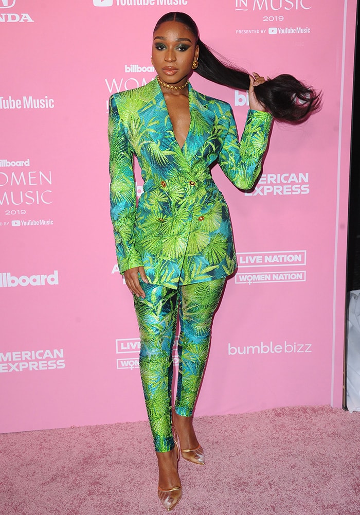 Normani wears a Versace suit featuring the fashion house's iconic jungle print 