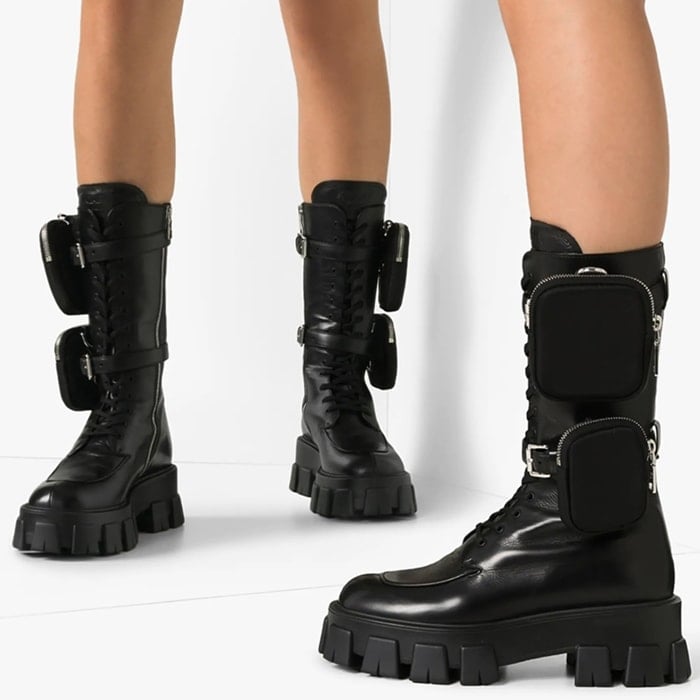 Designed in a mid-calf silhouette, this style features a round toe, lace-up front, detachable buckled straps with zipped pockets, side zip fastening and chunky tread sole