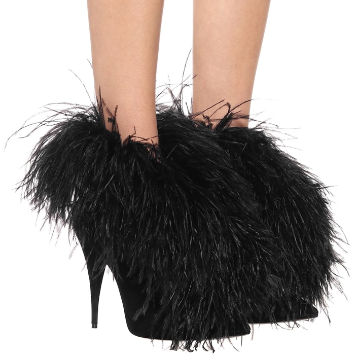 Crafted in Italy from suede, this point-toe silhouette is embellished with a string of feathers that protrude from the tops to drape down over the feet