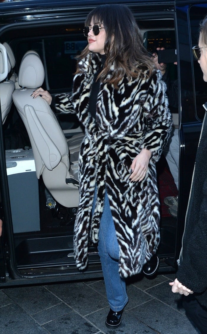 Selena Gomez rocks a zebra-print belted faux fur coat from Mango