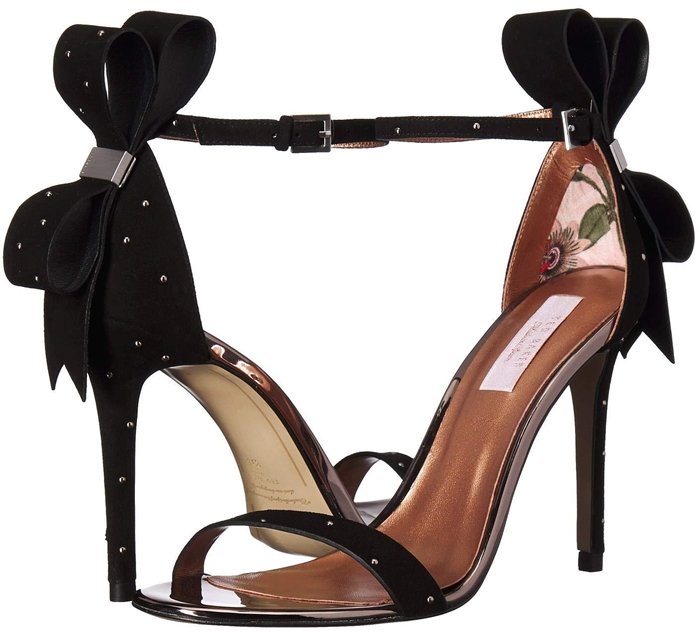 Polished studs and a dramatic bow at the heel add modern elegance to this lofty ankle-strap sandal