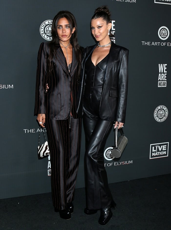 Jesse Jo Stark and Bella Hadid dressed in matching black outfits at the 2020 Art of Elysium Heaven Gala held at the Hollywood Palladium on January 4, 2020