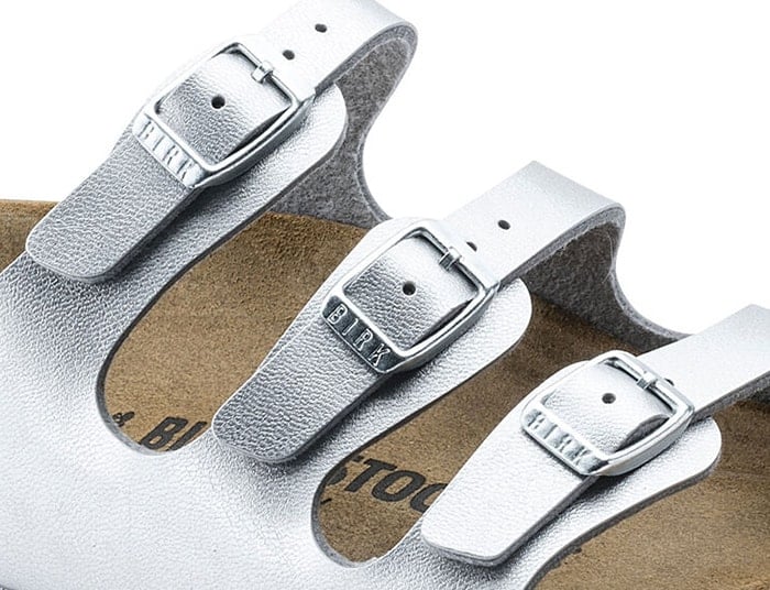 The Birkenstock 'Florida' sandals have three small buckles that show the "BIRK" logo