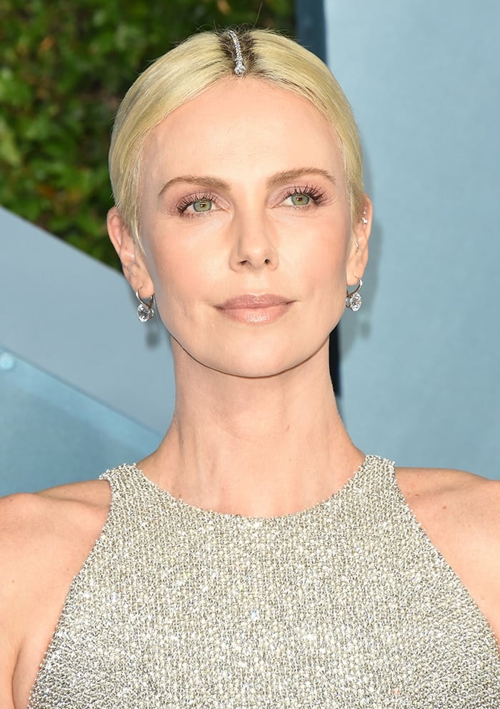 Charlize Theron wears Tiffany & Co. bracelet as a hair accessory to cover her roots