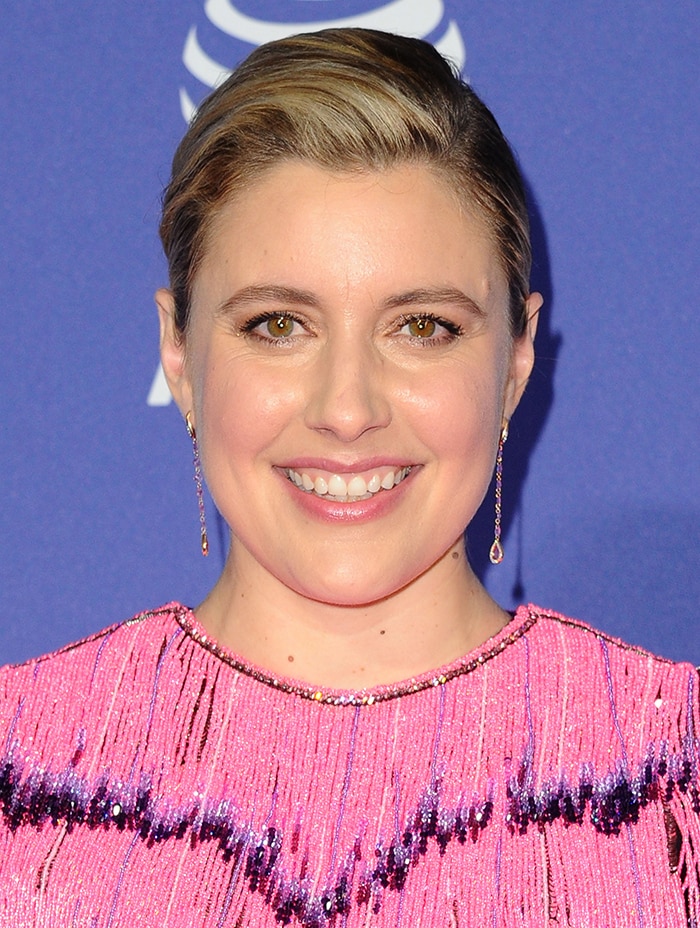 Greta Gerwig wears side-parted hair with pink-hued makeup