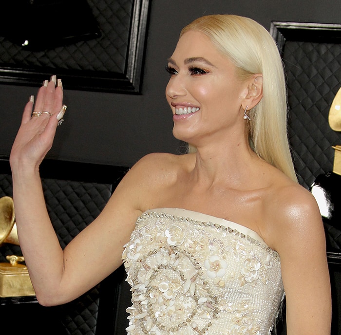 Gwen Stefani wears her platinum blonde locks straight and parted in the middle