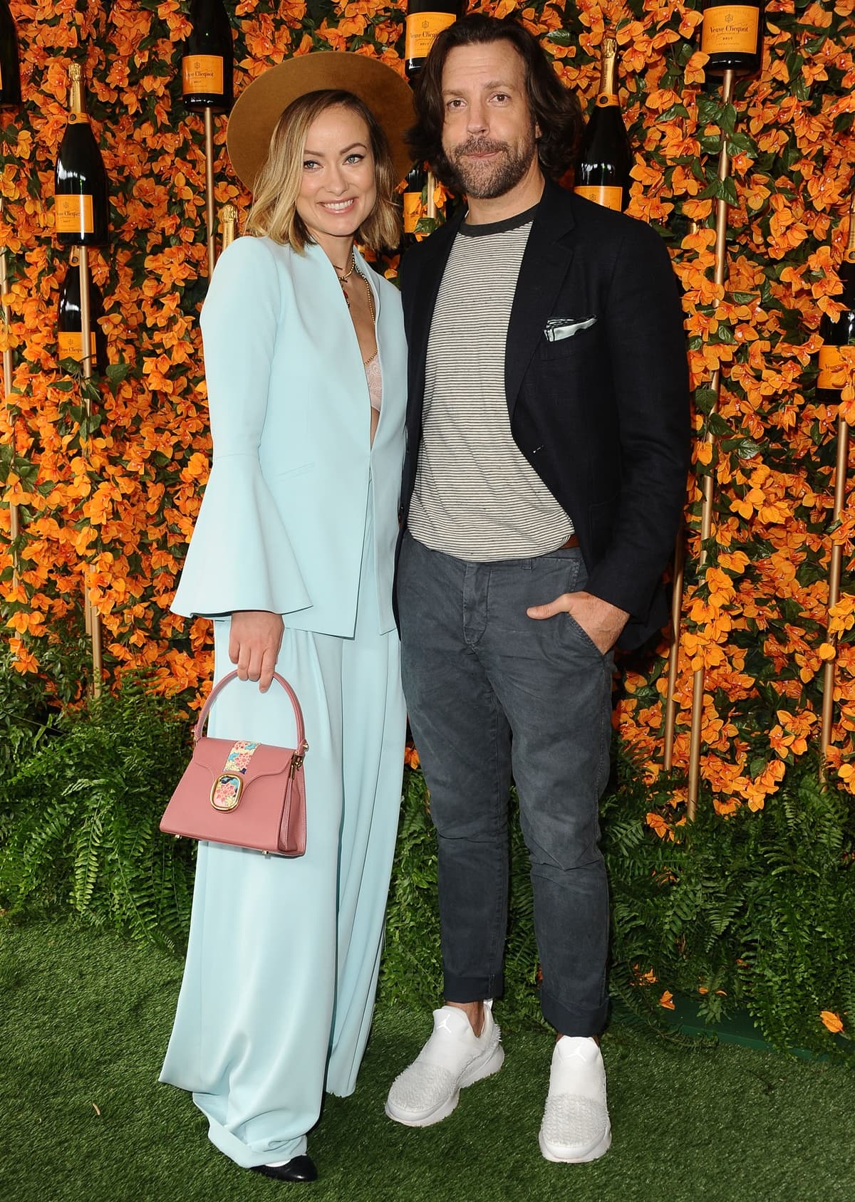 Olivia Wilde, wearing an Alice + Olivia suit with a Lidia May Pema bag and Foundrae jewelry, and Jason Sudeikis arrive at the 9th Annual Veuve Clicquot Polo Classic