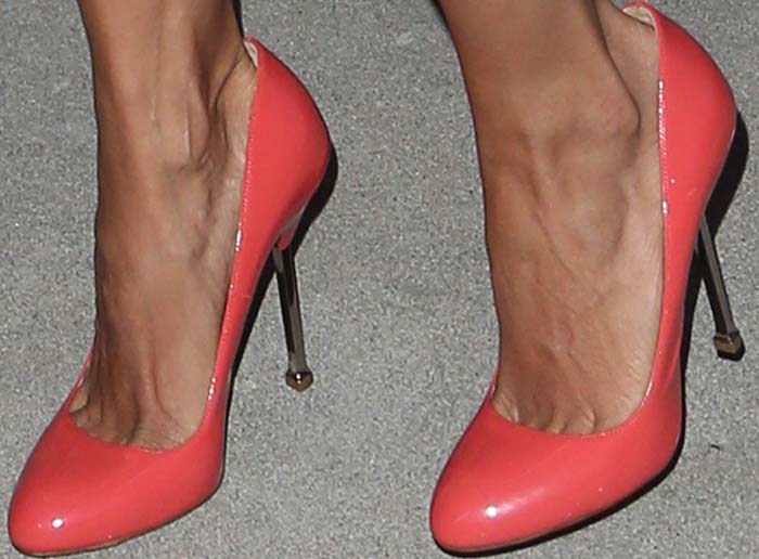 Rosario Dawson steps out in glossy salmon-pink Prada pumps featuring sleek metallic stiletto heels