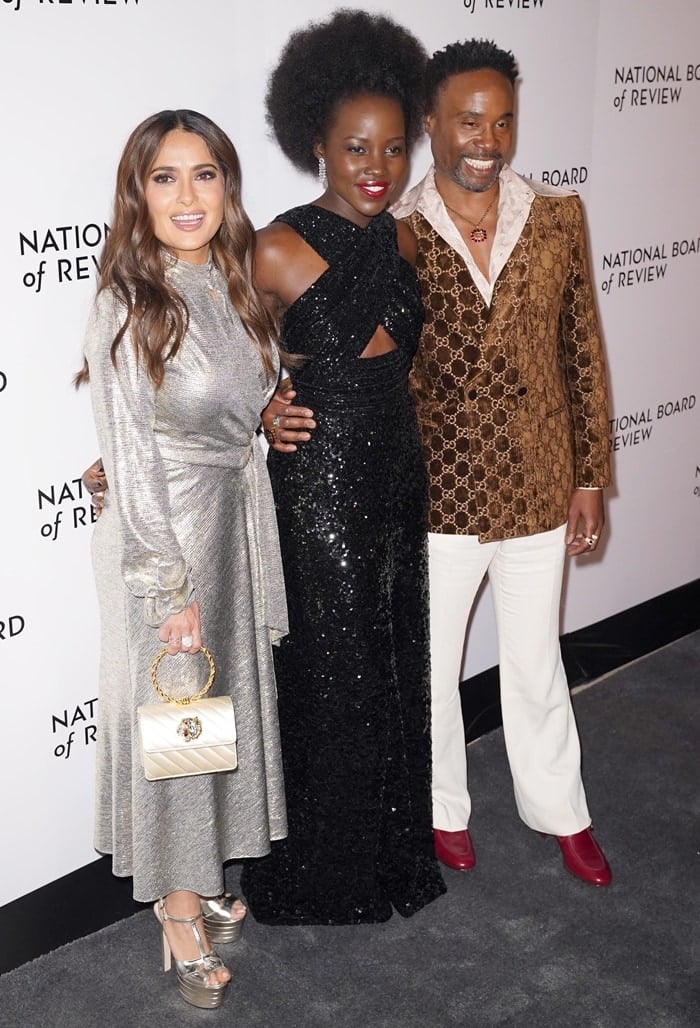 Salma Hayek, Lupita Nyong'o, and Billy Porter brought glamour to the 2020 National Board of Review Gala in NYC on January 8, 2020—Salma dazzled in a metallic silver dress and platform heels, Lupita stunned in a sequined cutout gown with Cartier jewelry, and Billy turned heads in a velvet Gucci blazer with red boots
