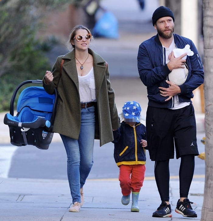 Teresa Palmer keeps it effortlessly chic in a white tee, olive green coat, skinny jeans, and nude espadrilles as she leaves Café Gratitude in Larchmont Village with her husband, Mark Webber, and their kids, Bodhi and newborn Forest, on January 13, 2017