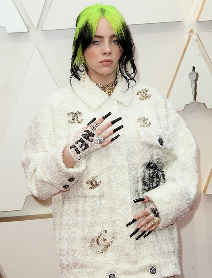 Billie Eilish wears Chanel accessories and long black nails with jeweled tips