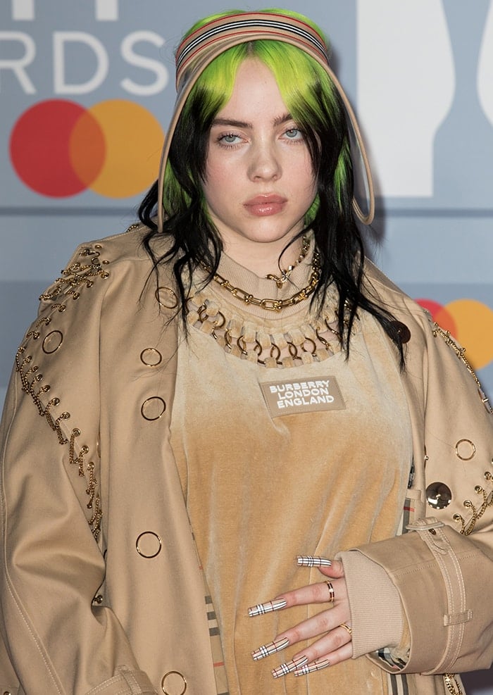 Billie Eilish completes her Burberry look with long plaid nails and sun visor