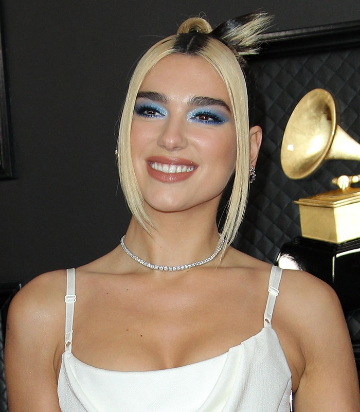 Dua Lipa wears '90s smokey blue eyeshadow and topknot hairstyle