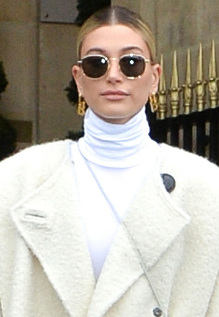 Hailey Bieber styles her look with Balenciaga earrings and Saint Laurent sunnies