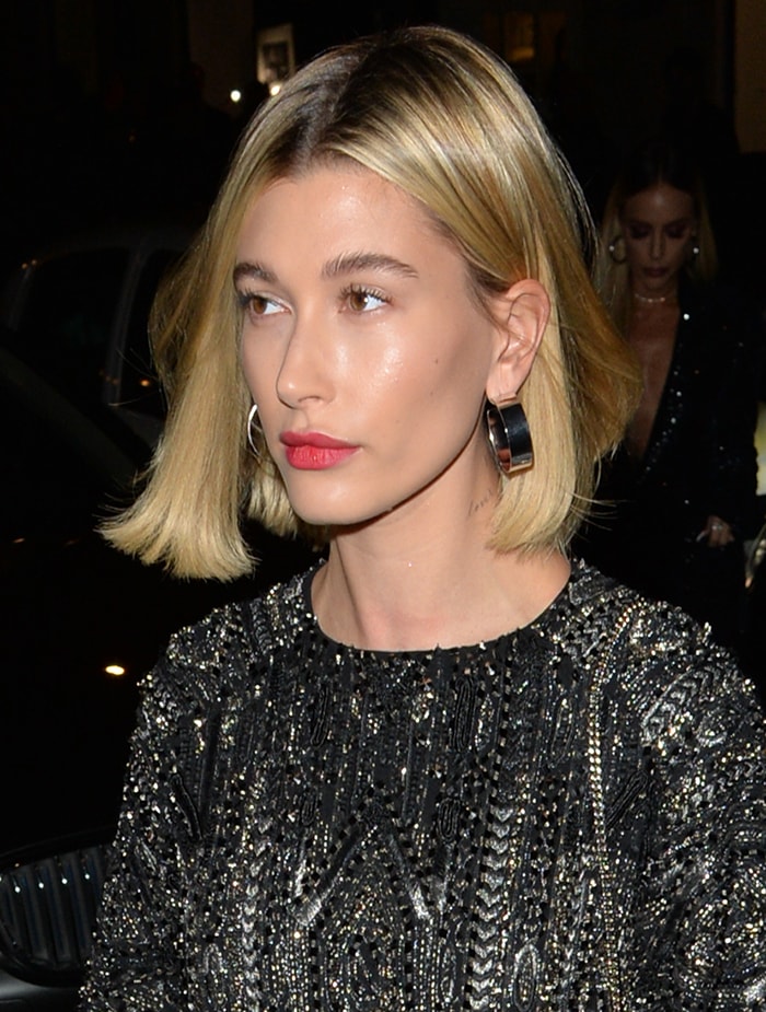 Hailey Bieber wears her bob straight with fuchsia lipstick