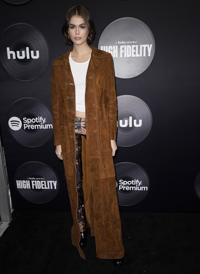 Kaia Gerber Leaves Chloé Fashion Show in Bell Boots & Nanushka Manila Coat