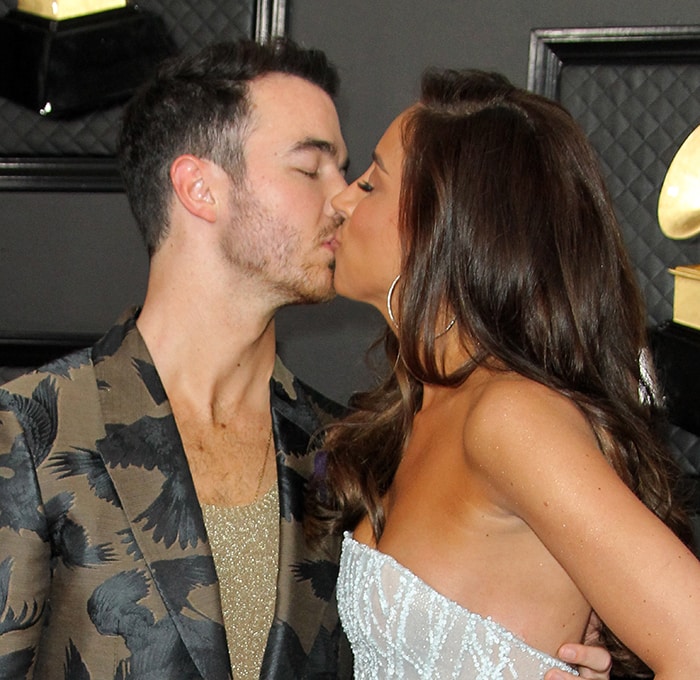 Kevin and Danielle Jonas share a kiss on the Grammy red carpet