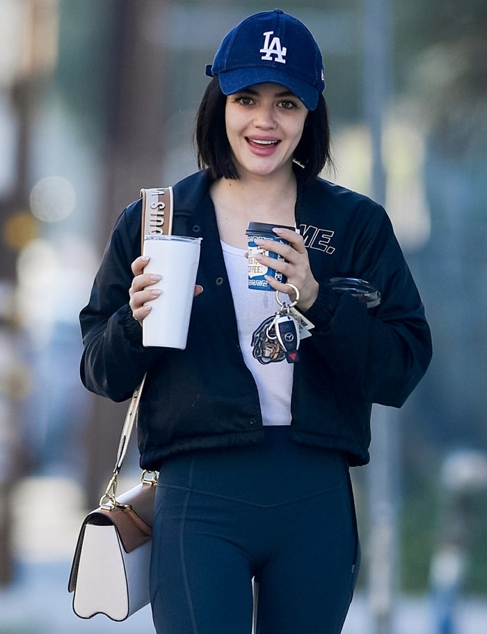 Lucy Hale carrying a dog keyring from Givenchy and a Twist MM handbag from Louis Vuitton