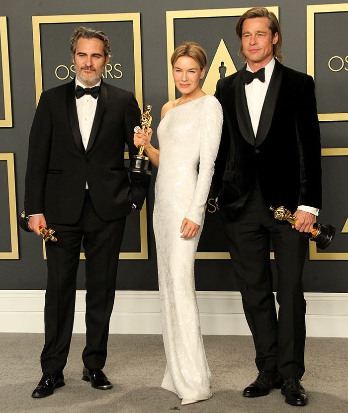 Academy Awards winners Joaquin Phoenix, Renee Zellweger, and Brad Pitt pose together with their Oscar trophies