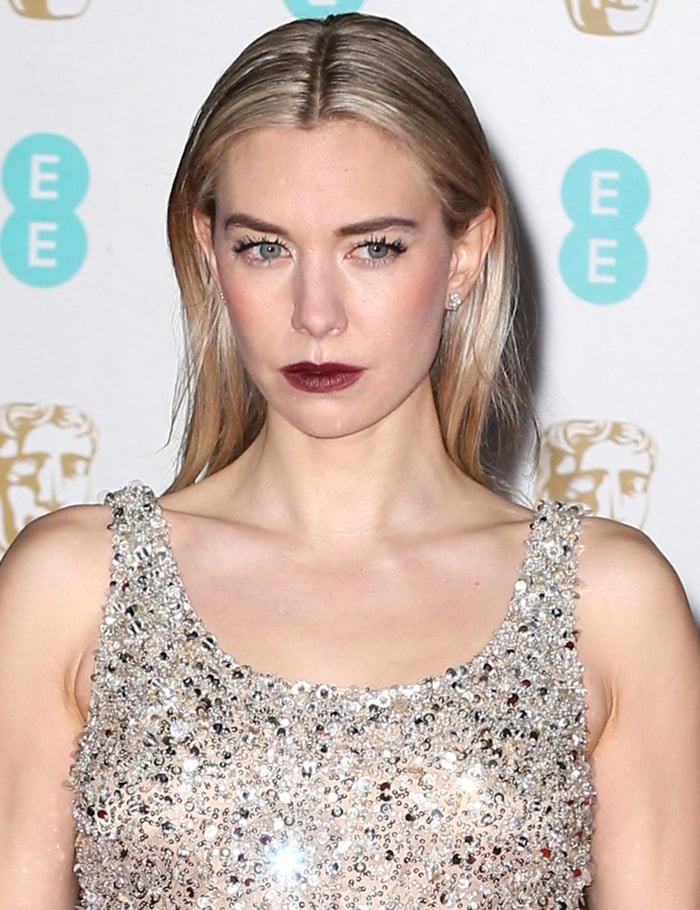 Vanessa Kirby amps up the edge with maroon lipstick and sleek center-parted hairstyle