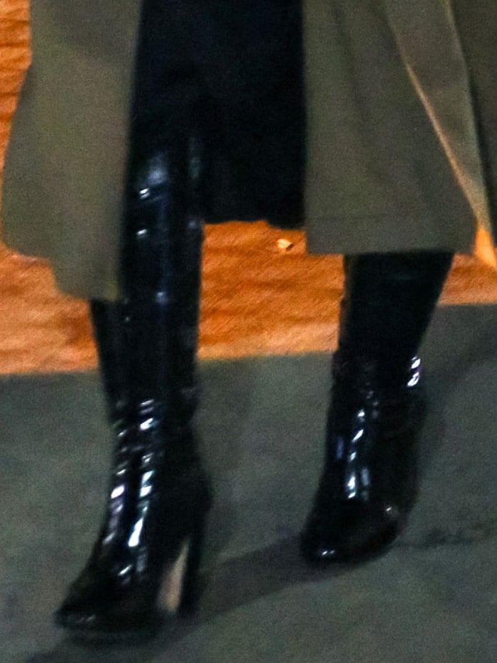 Christina Aguilera teams her dress with black latex knee-high boots