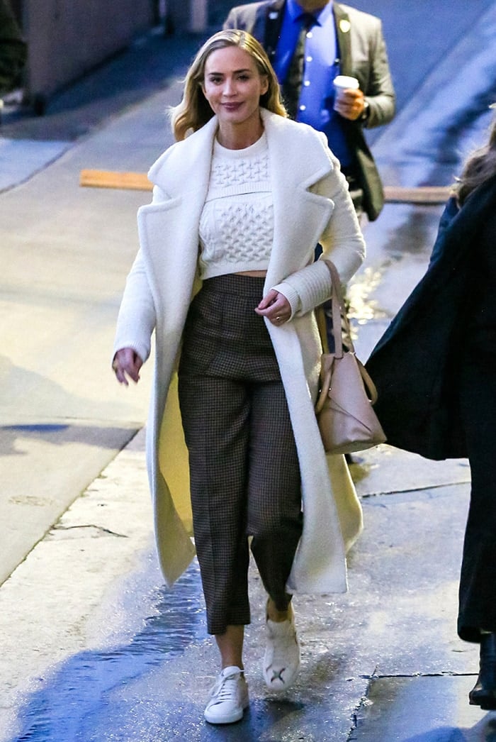 Emily Blunt leaving Jimmy Kimmel Live studios in white knit crop top and long coat