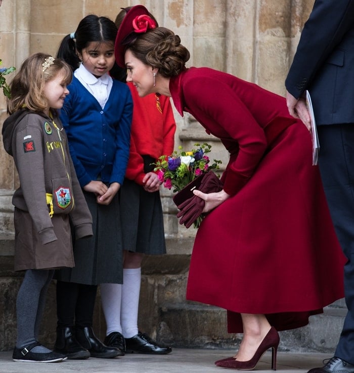 Kate Middleton wears a ruby-colored Sally-Ann Provan Sada felt saucer felt hat