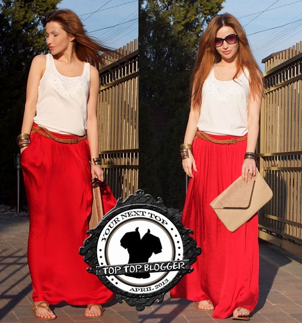 Tor wears a white shirt with a long red maxi skirt