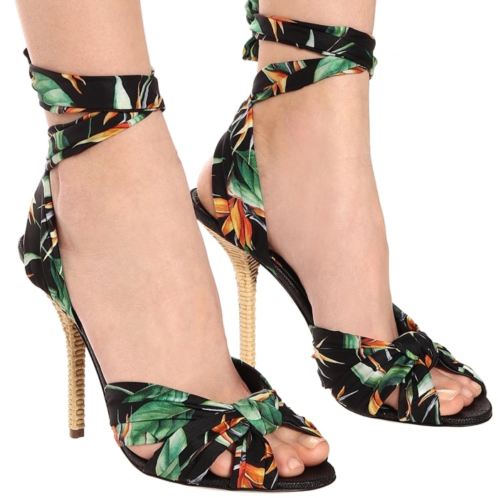 Tropical flowers color a silk ankle-tie sandal lifted by a wicker-textured statement heel