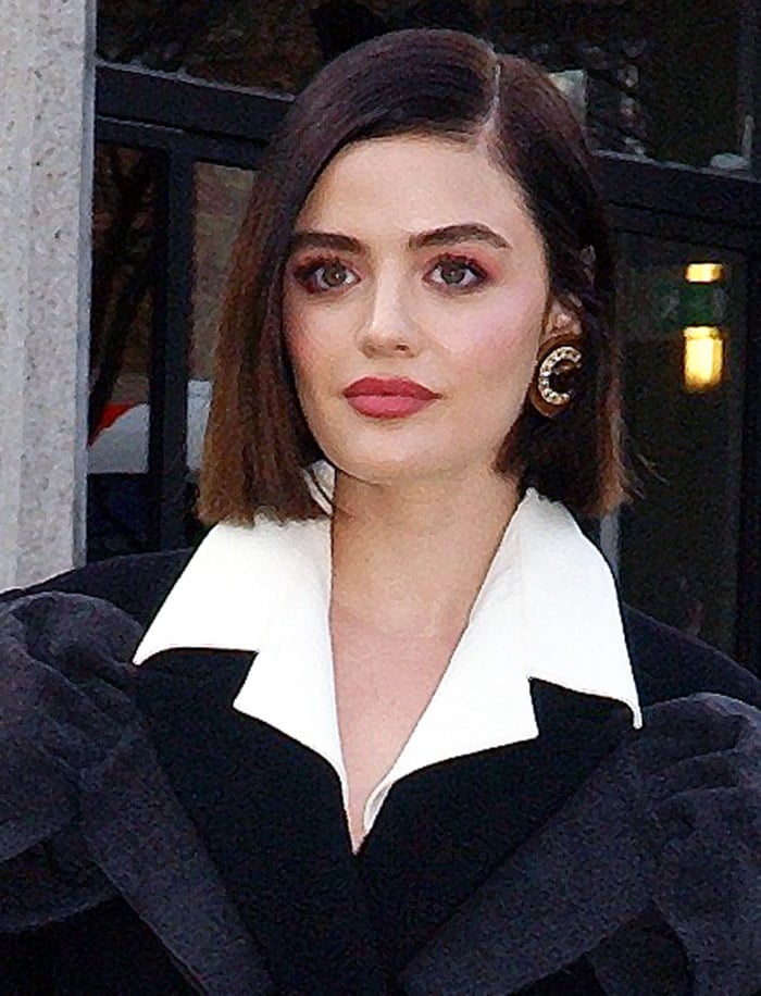 Lucy Hale wears dark pink makeup and styles her short bob straight with a side parting