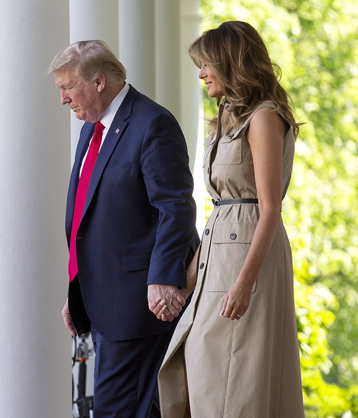 Donald Trump dons a navy suit while Melania Trump wears a Christian Dior trench dress