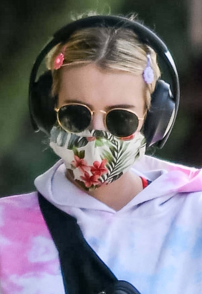 Emma Roberts rocks a floral face mask, Ray-Ban sunglasses, and Scunci girl flower snap clips