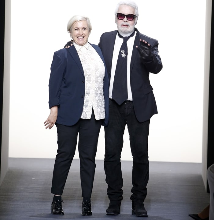 Italian designer Silvia Venturini Fendi and German fashion designer Karl Lagerfeld acknowledge the applause of the audience at the Fendi show