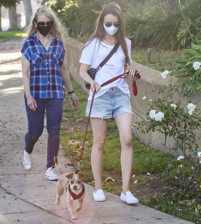 Jill Tavelman and Lily Collins wear masks while taking pup Redford out for a walk