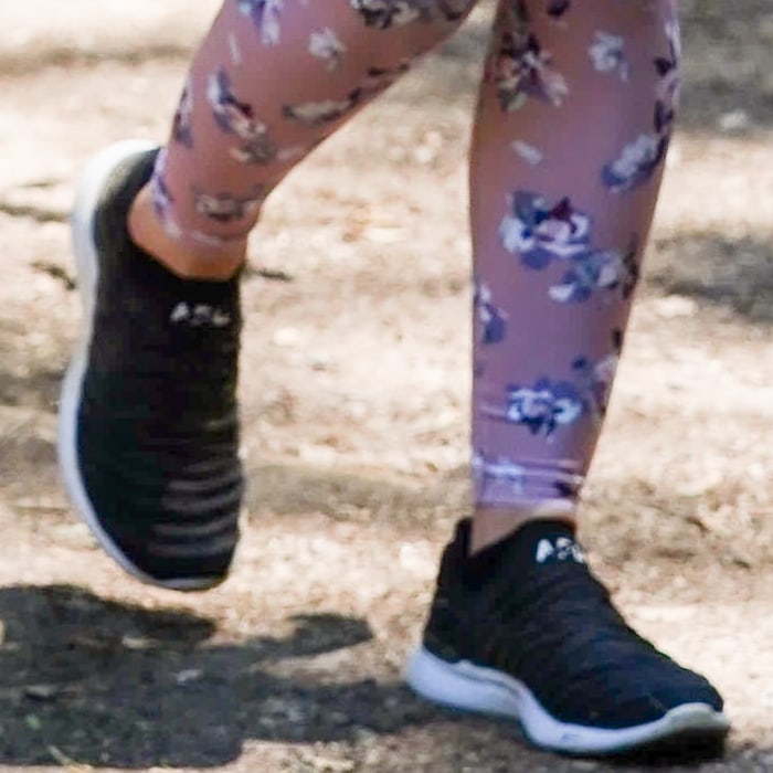 Lucy Hale styled her floral yoga pants with gorgeous black and white sneakers from Athletic Propulsion Labs (APL)